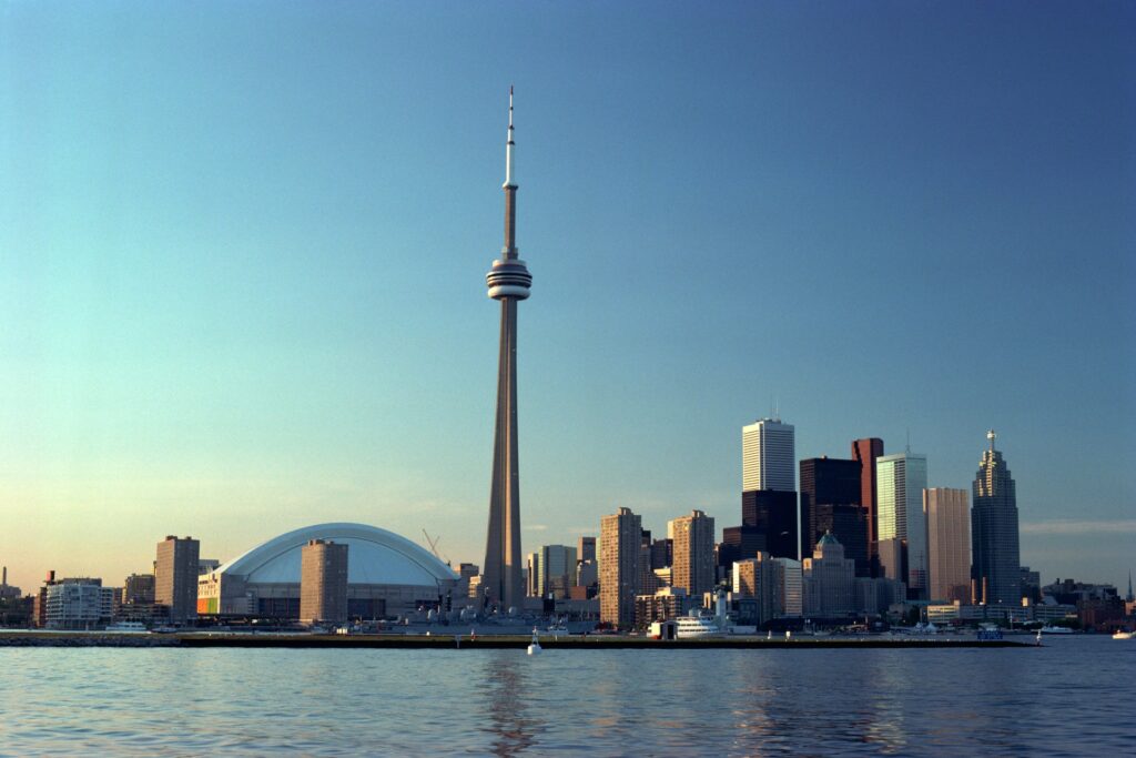 A view of the Toronto skyline from Lake Ontario showing the CN Tower, Rogers Centre, and various office and apartment buildings, representing Best Lawyers Canada.