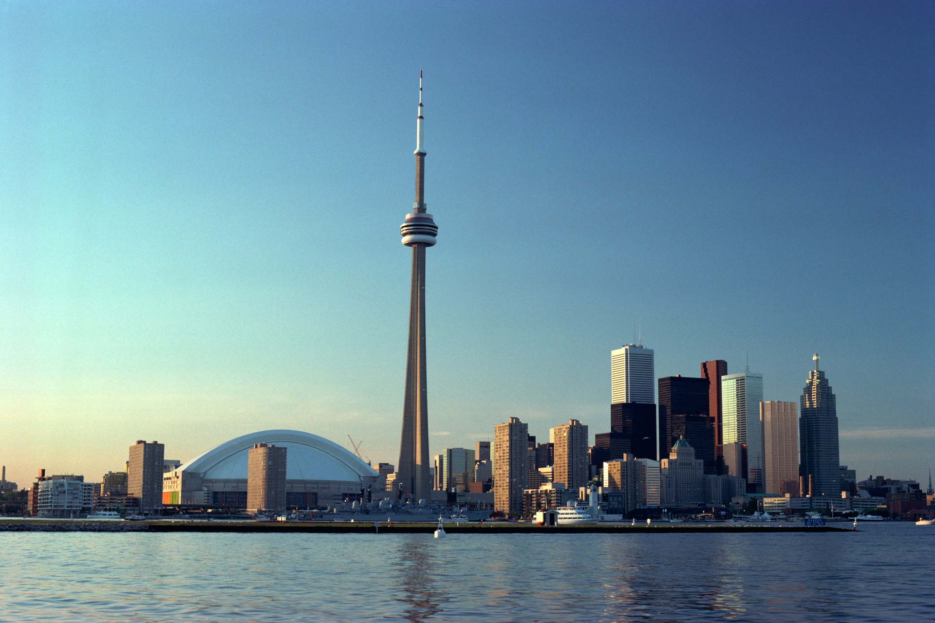 A view of the Toronto skyline from Lake Ontario showing the CN Tower, Rogers Centre, and various office and apartment buildings, representing Best Lawyers Canada.