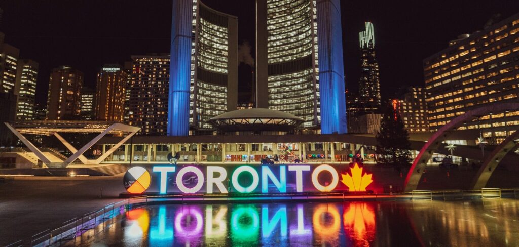 Nighttime view of the Toronto sign in front of City Hall, representing Boulby Weinberg Fishman LLP’s recognition in the 2026 Best Law Firms - Canada list.